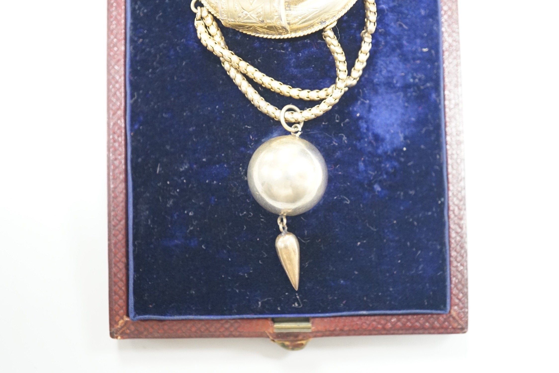 A Victorian gilt white metal drop brooch, with central buckle motif and spherical drop, 80mm, in fitted leather case.